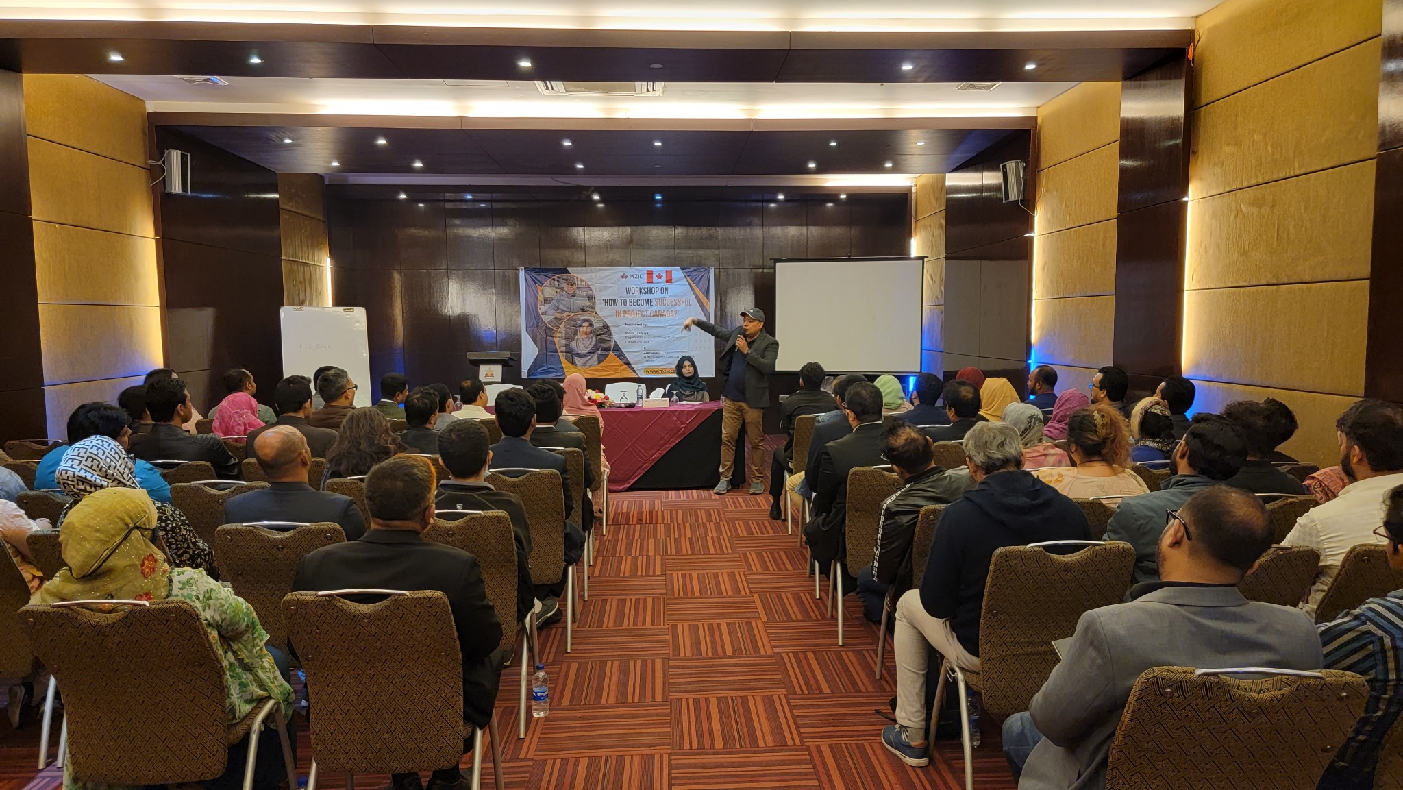 Zia Hasan speaking at a large professional workshop